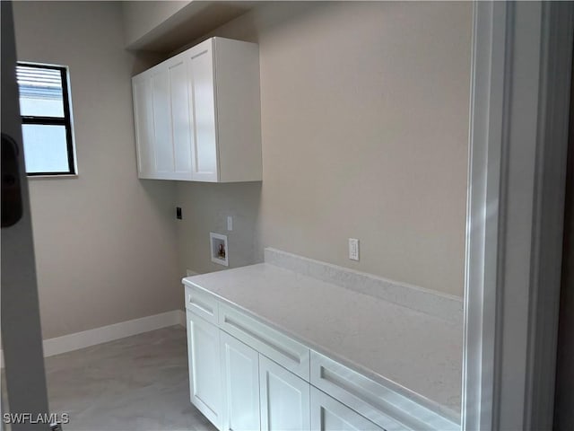 clothes washing area featuring cabinets and washer hookup