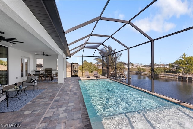 view of swimming pool featuring a water view, a lanai, ceiling fan, and a patio area