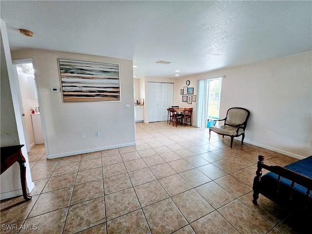 sitting room featuring light tile patterned floors and a textured ceiling