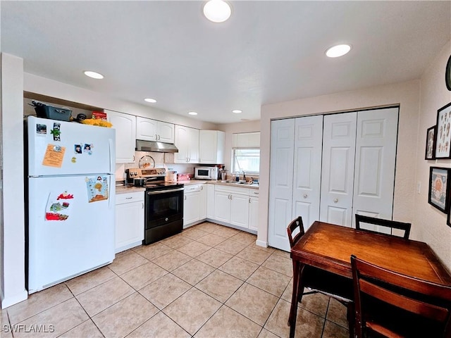 kitchen featuring light tile patterned floors, white appliances, white cabinetry, and sink