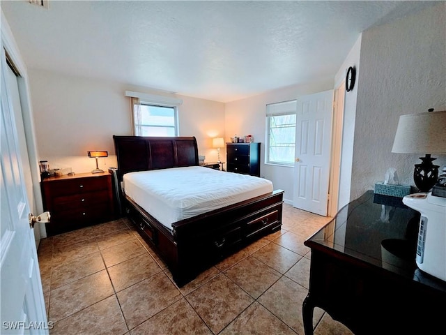 bedroom with light tile patterned floors