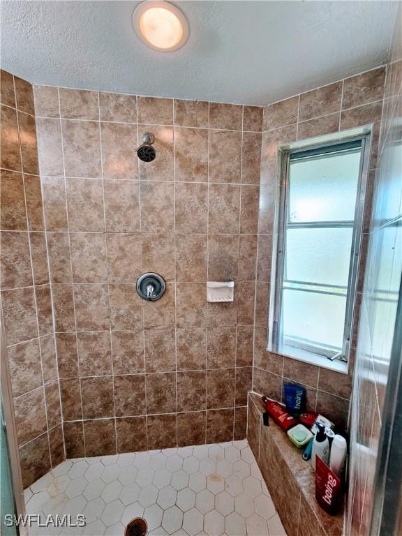 bathroom with tiled shower