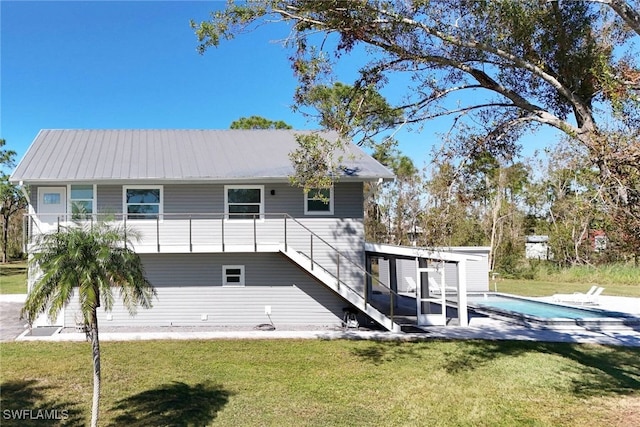 rear view of house featuring a lawn