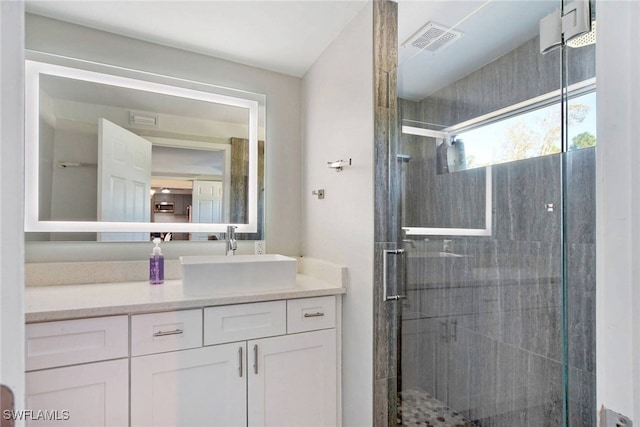 bathroom featuring vanity and a shower with shower door