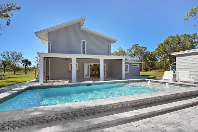 view of pool featuring a lawn and a patio area