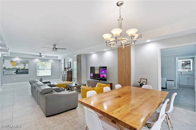 dining area featuring ceiling fan with notable chandelier and light tile patterned flooring