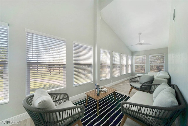 sunroom featuring a wealth of natural light, lofted ceiling, and ceiling fan