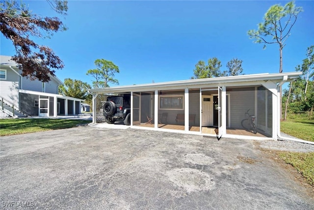 back of property with a carport