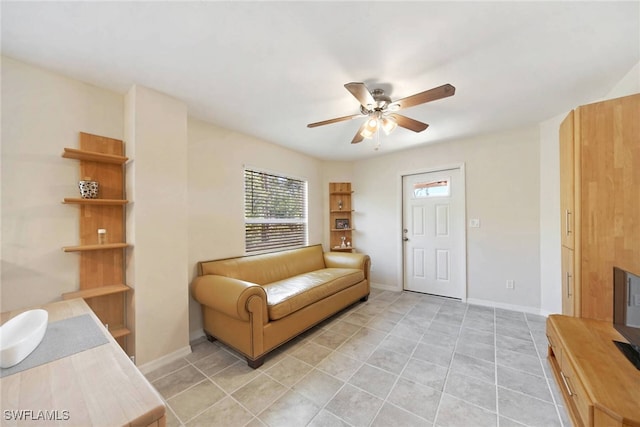 sitting room with light tile patterned floors and ceiling fan