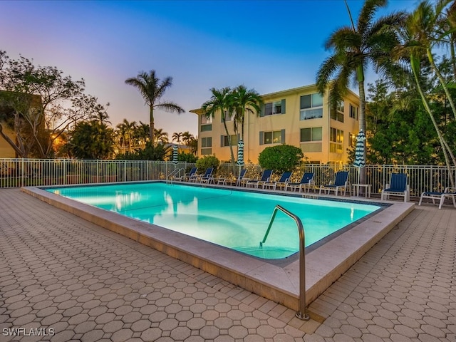 view of pool at dusk