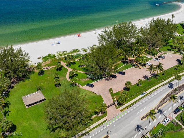 drone / aerial view with a water view and a beach view