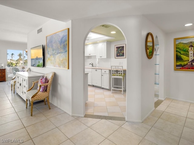 corridor featuring light tile patterned floors