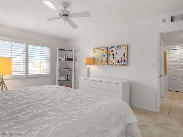 tiled bedroom featuring ceiling fan