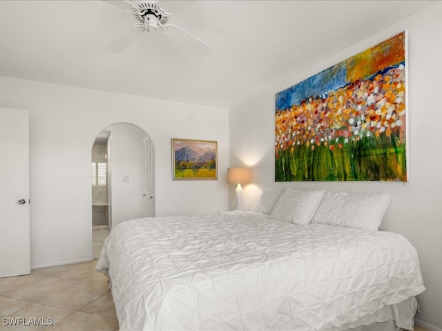 tiled bedroom featuring ceiling fan