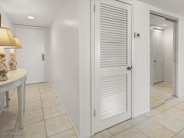 corridor featuring light tile patterned floors