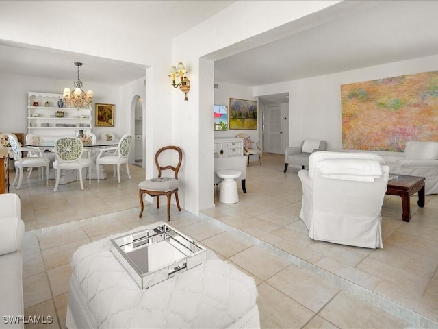 1930 Gulf Shore Blvd N Unit D301, Naples, FL 34102 - living area with a chandelier, arched walkways, and tile patterned floors