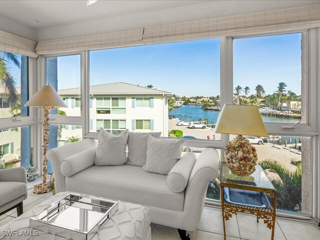 sunroom featuring a water view and a wealth of natural light