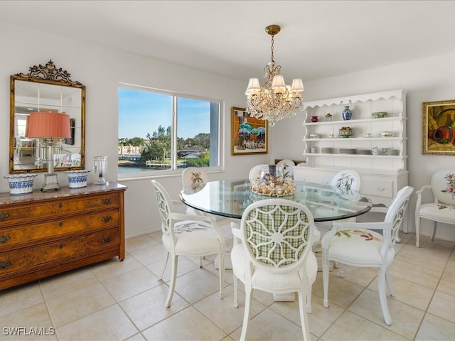 tiled dining room featuring a chandelier