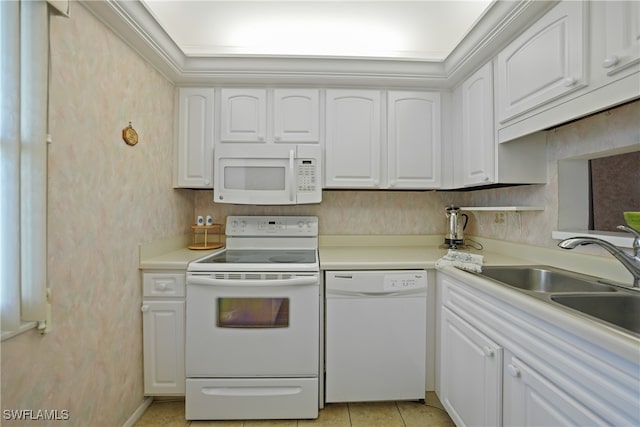 kitchen with sink, white cabinets, light tile patterned flooring, and white appliances