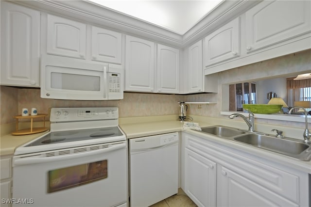 kitchen with sink, white cabinets, white appliances, and light tile patterned floors