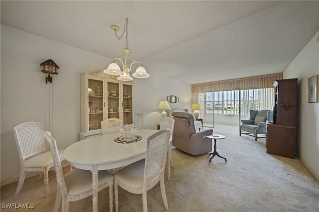 carpeted dining area with a textured ceiling and an inviting chandelier