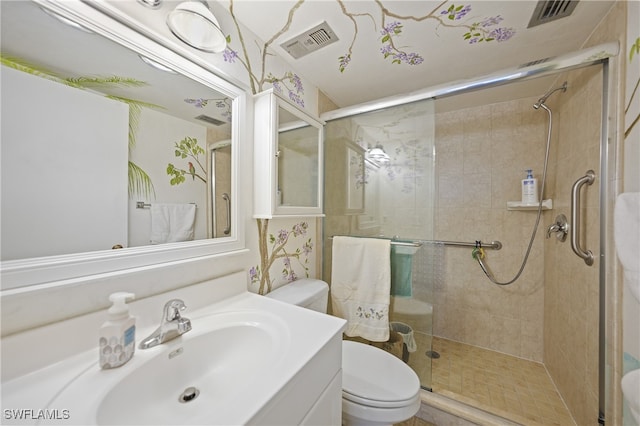 bathroom with an enclosed shower, vanity, and toilet