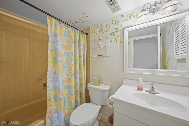 full bathroom featuring shower / bath combo with shower curtain, vanity, a textured ceiling, and toilet