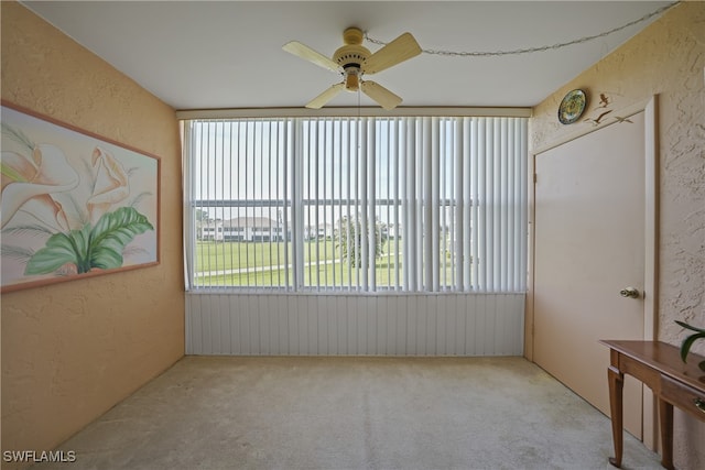 sunroom / solarium with ceiling fan and plenty of natural light