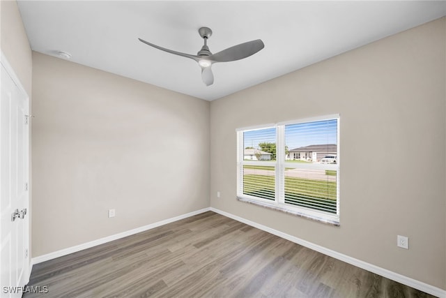 spare room with hardwood / wood-style floors and ceiling fan