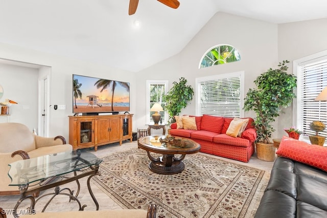 living room with ceiling fan and high vaulted ceiling