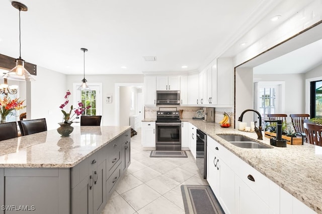 kitchen featuring light stone countertops, sink, white cabinets, and appliances with stainless steel finishes