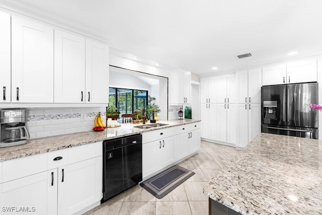 kitchen with light stone countertops, stainless steel refrigerator with ice dispenser, sink, dishwasher, and white cabinetry