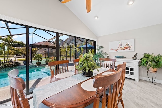 dining room with light tile patterned floors, high vaulted ceiling, and ceiling fan