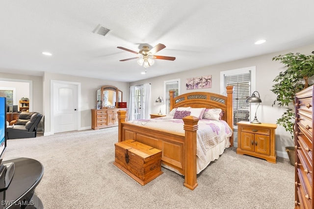 bedroom with ceiling fan and light carpet