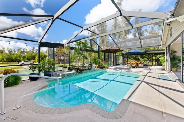 view of swimming pool featuring glass enclosure and a patio