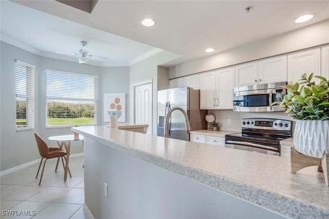 kitchen featuring white cabinetry, crown molding, light tile patterned floors, ceiling fan, and stainless steel appliances