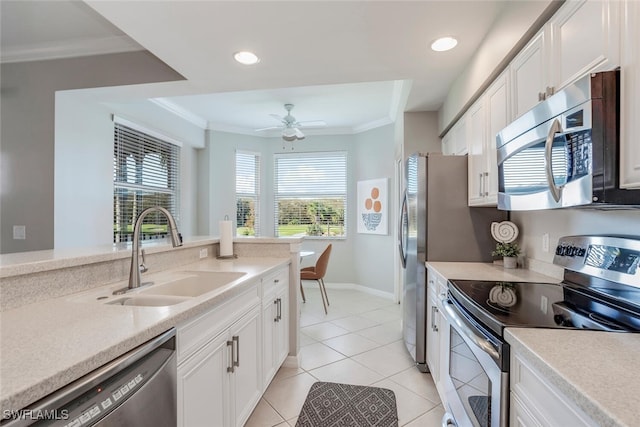 kitchen featuring crown molding, appliances with stainless steel finishes, sink, and white cabinets