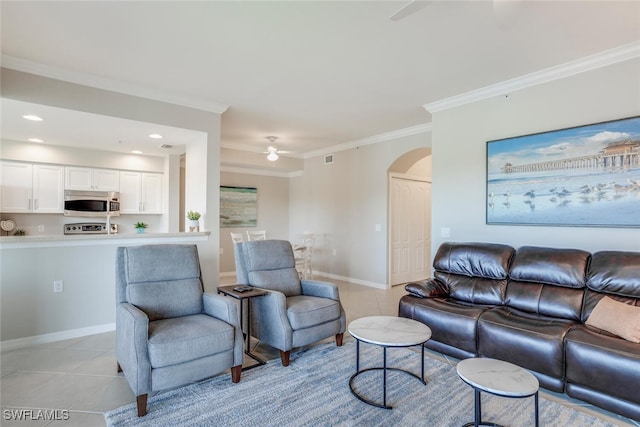 living room featuring light tile patterned floors, ornamental molding, and ceiling fan