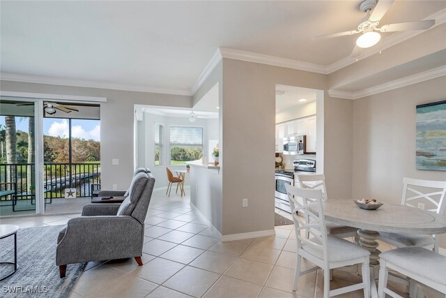 dining room featuring light tile patterned flooring, ceiling fan, and ornamental molding