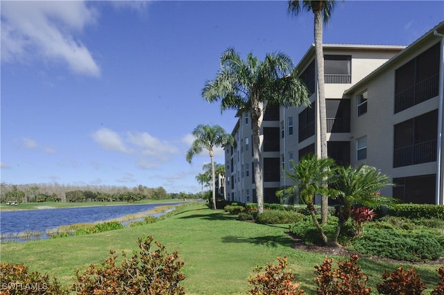 view of property's community featuring a yard and a water view