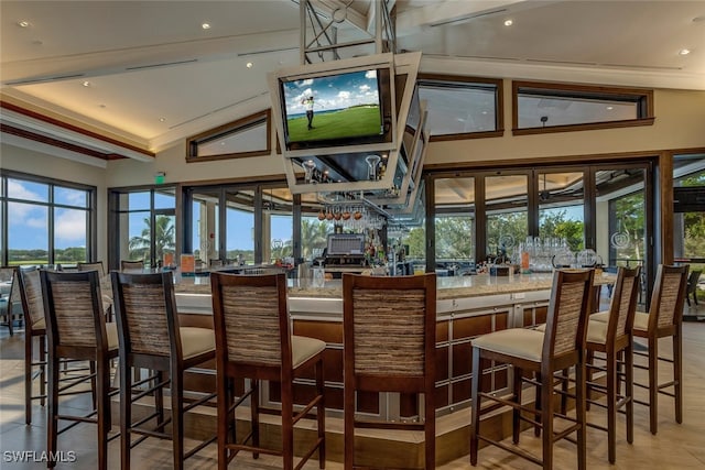 bar featuring vaulted ceiling with beams