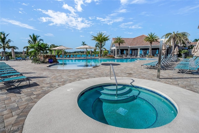 view of swimming pool with a patio and a community hot tub