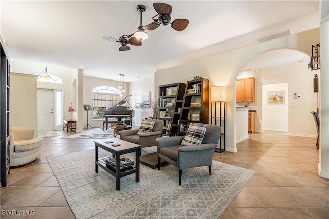 tiled living room featuring ceiling fan