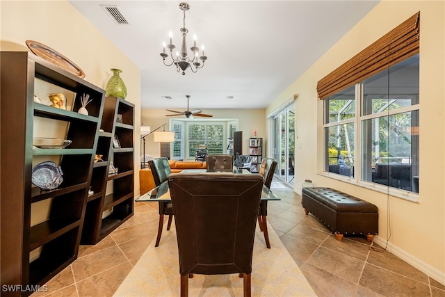 dining area with ceiling fan with notable chandelier