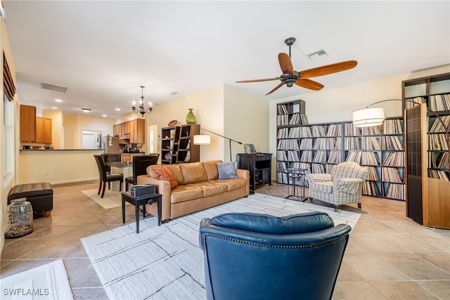 living room with ceiling fan with notable chandelier