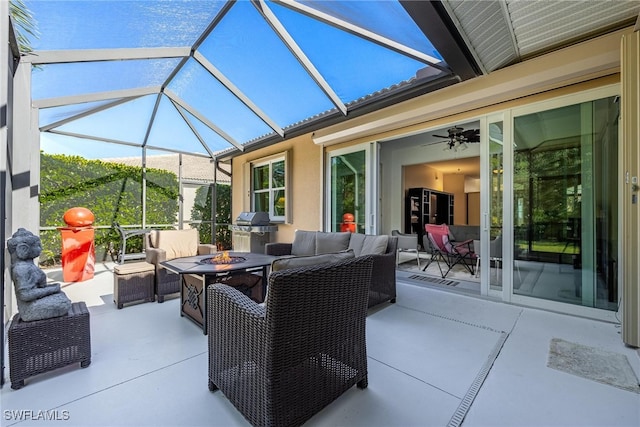 view of patio with an outdoor living space with a fire pit