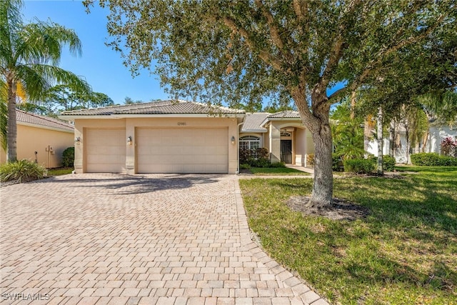 view of front of house with a front yard and a garage