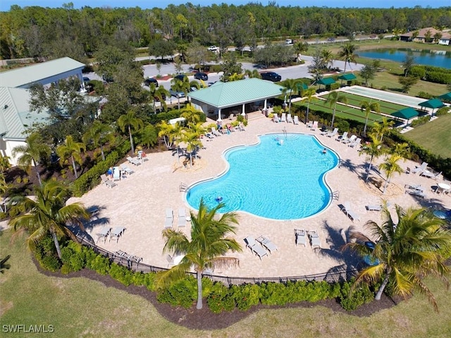 view of pool featuring a water view and a patio