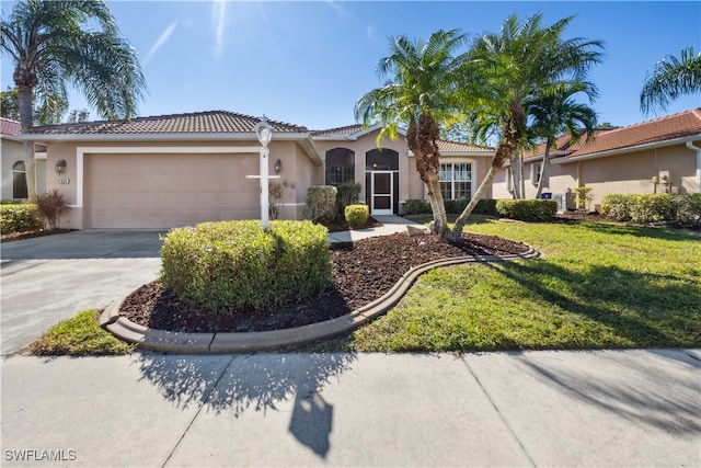 mediterranean / spanish-style house with a garage and a front yard