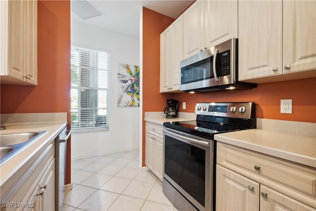 kitchen with light tile patterned floors and appliances with stainless steel finishes